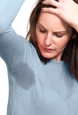 woman with hyperhidrosis sweating through her shirt